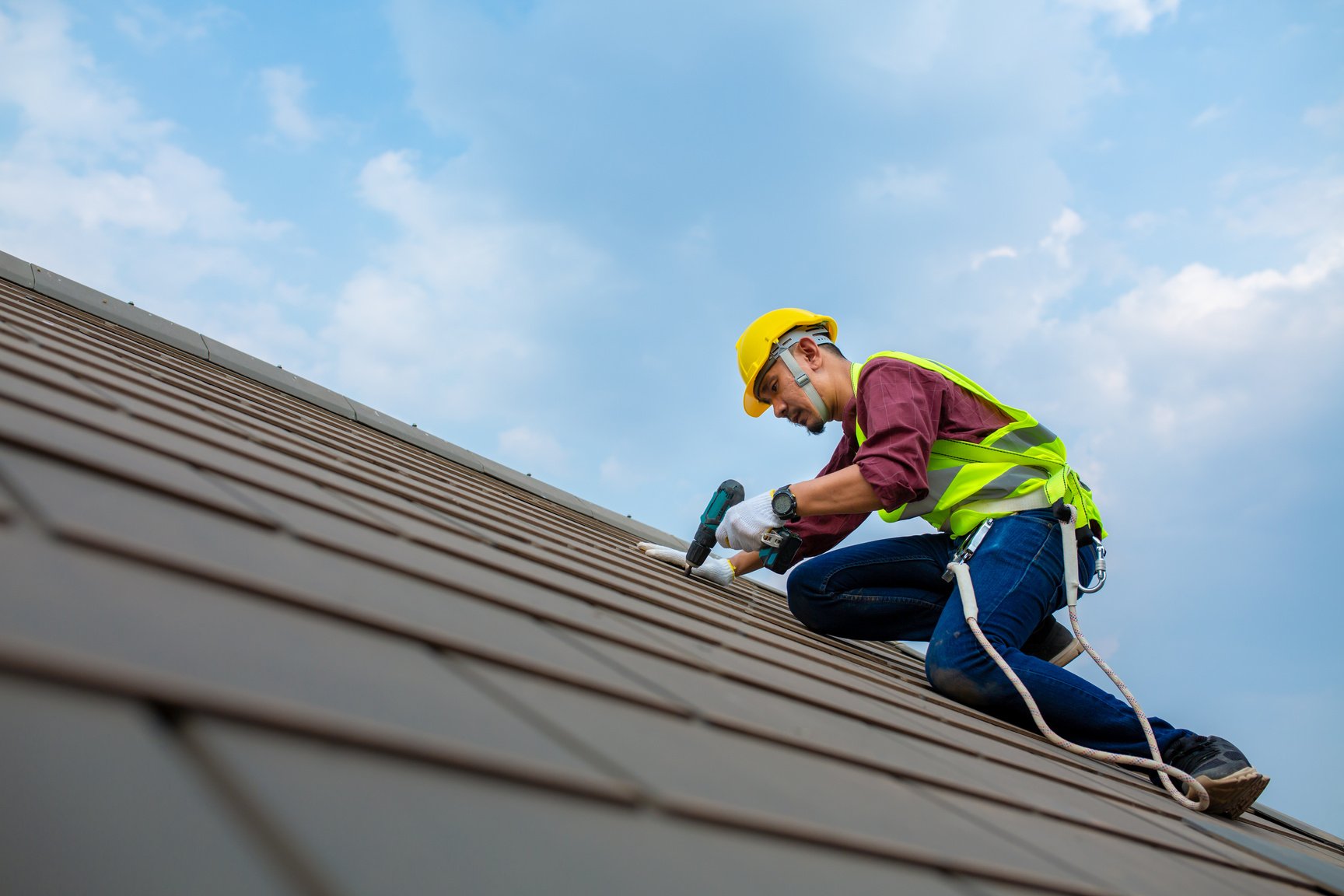 Construction Worker Fixing Roof Tiles